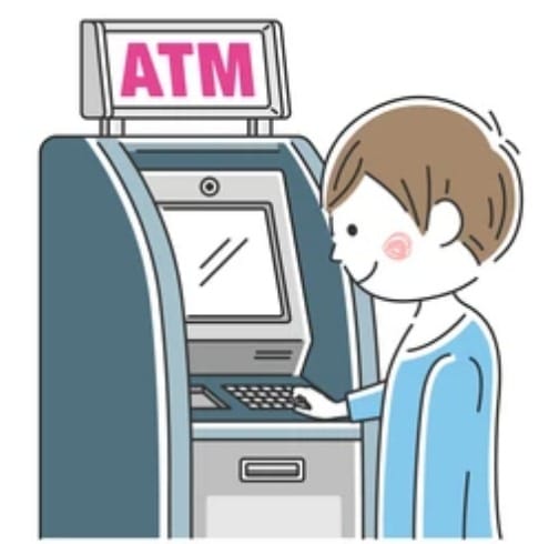 A boy is standing at an atm machine.