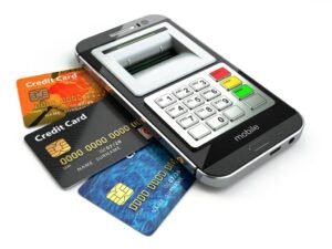 A smart phone with credit cards on the screen.