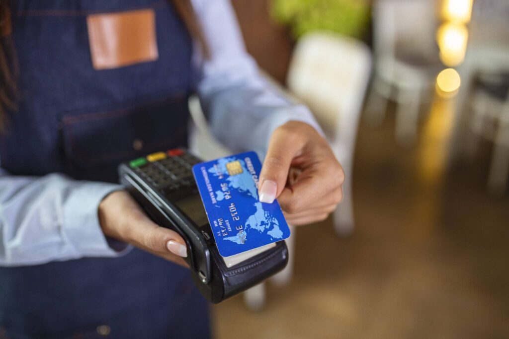 A person holding a credit card in their hand.