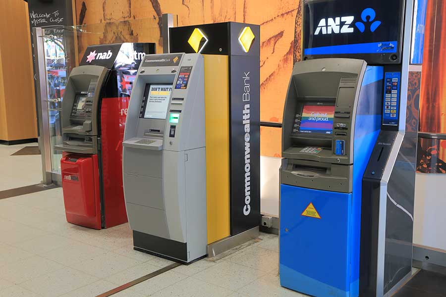 A row of atm machines in different colors.