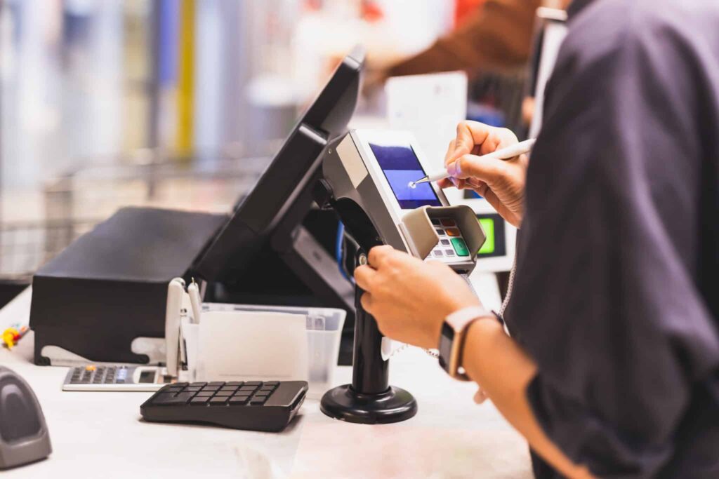 A person using a tablet to pay for something.