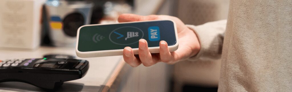 A person holding an iphone with the pay button on it.