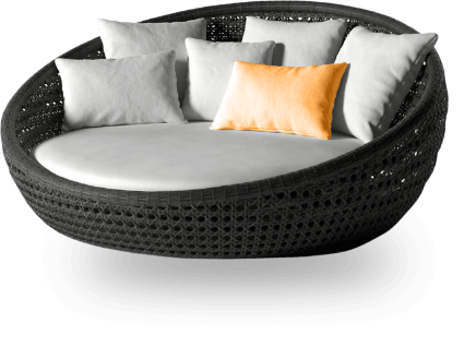 A round couch with pillows on top of it.