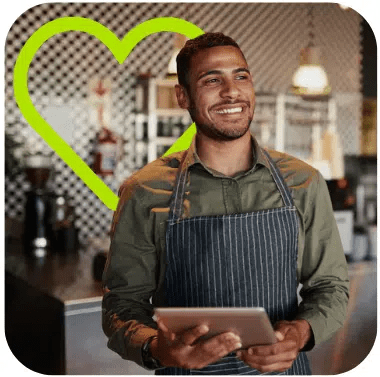 A man in an apron holding a tablet.